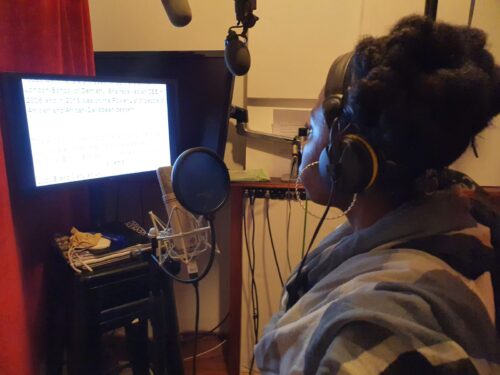 Dani Mosely in a recording studio reading the Brown Babies script