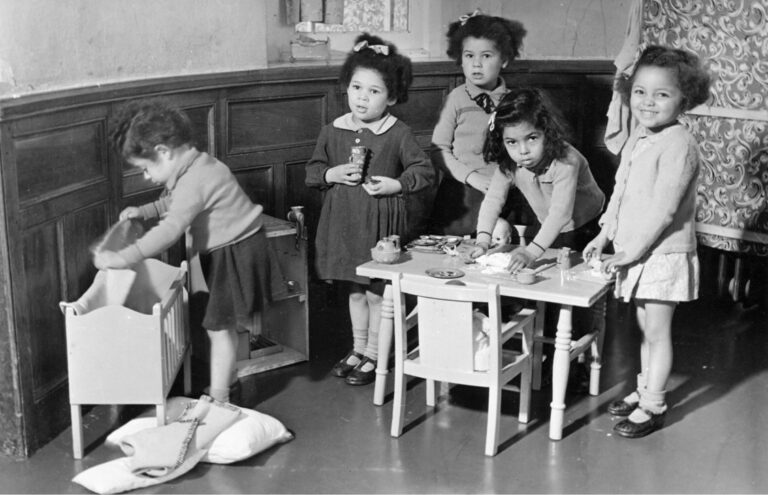 A group of mixed race children playing at Holnicote House in the 1950s